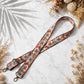 Floral patterned strap on a marble surface with dried flowers