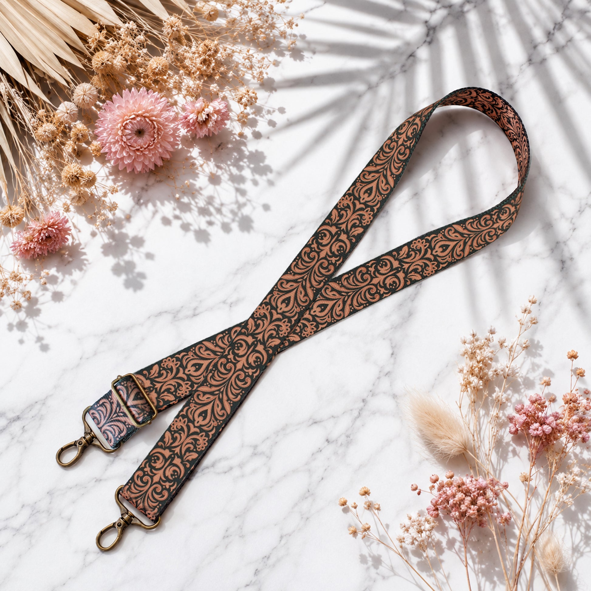 Decorative strap with floral pattern on a light surface with flowers and leaves.