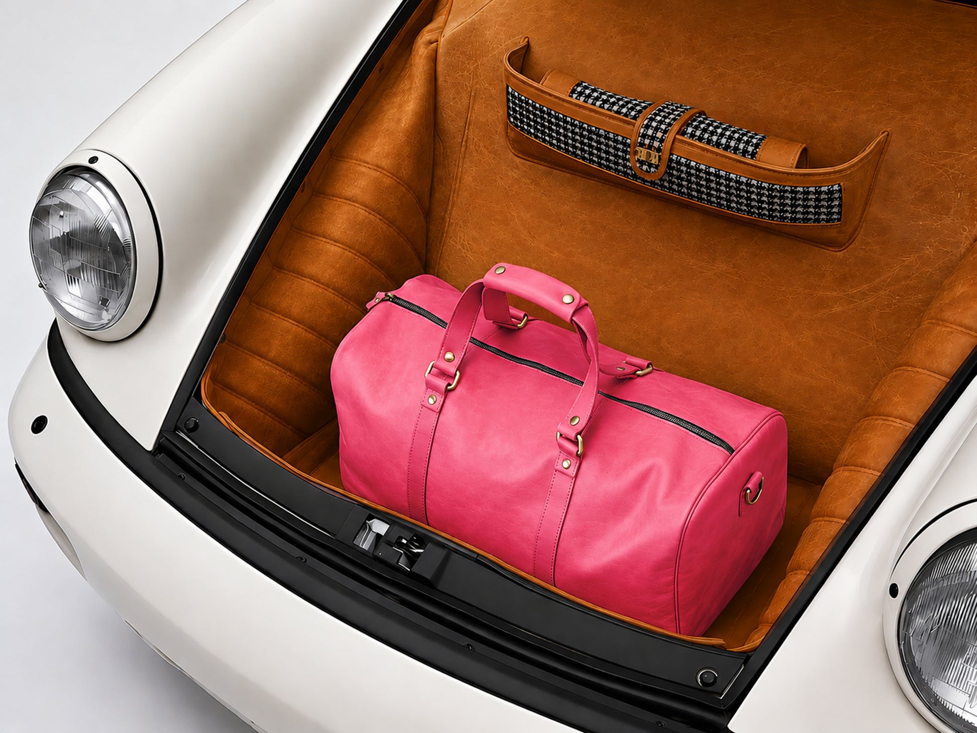 Pink duffel bag in the trunk of a car with a brown interior.