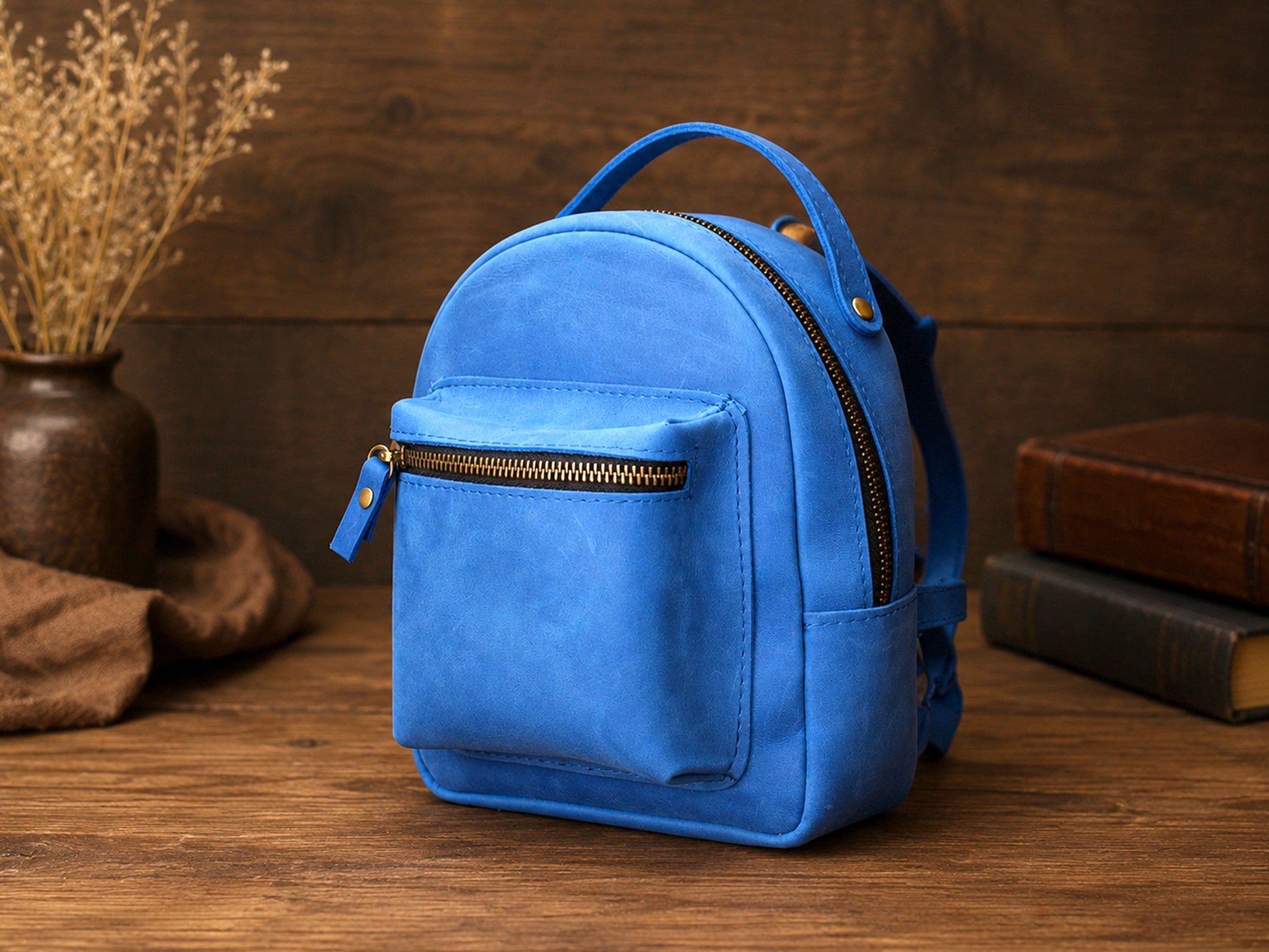 Blue backpack on a wooden surface with a brown background