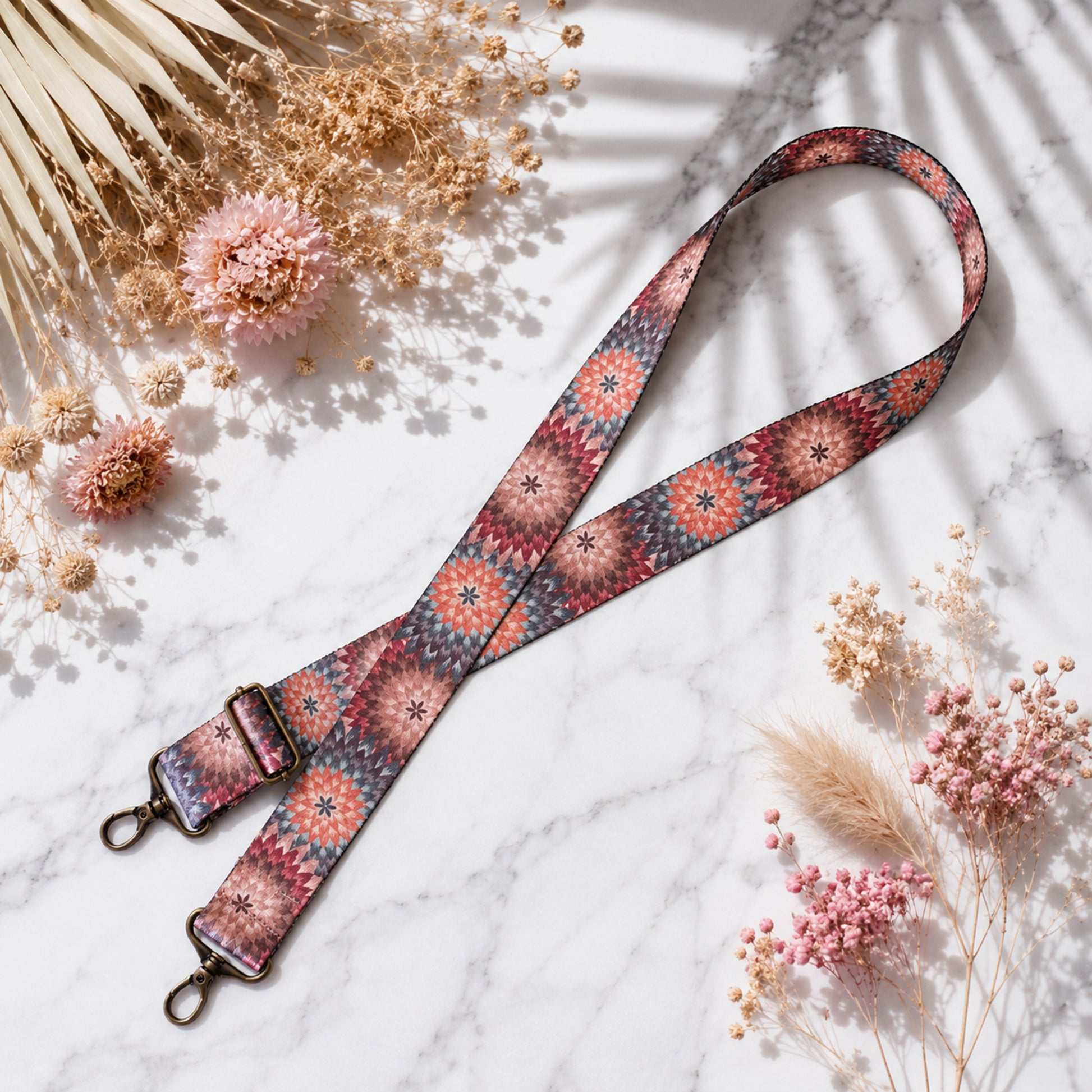 Floral patterned lanyard on a marble surface with dried flowers
