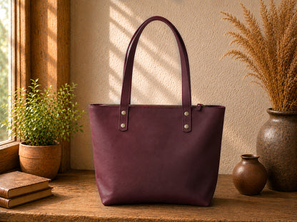 Multiple leather tote bags with monogram initials on textured surface