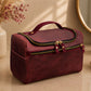 Maroon toiletry bag on a bathroom counter with decorative elements