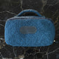 Blue textured pouch on a black marble surface