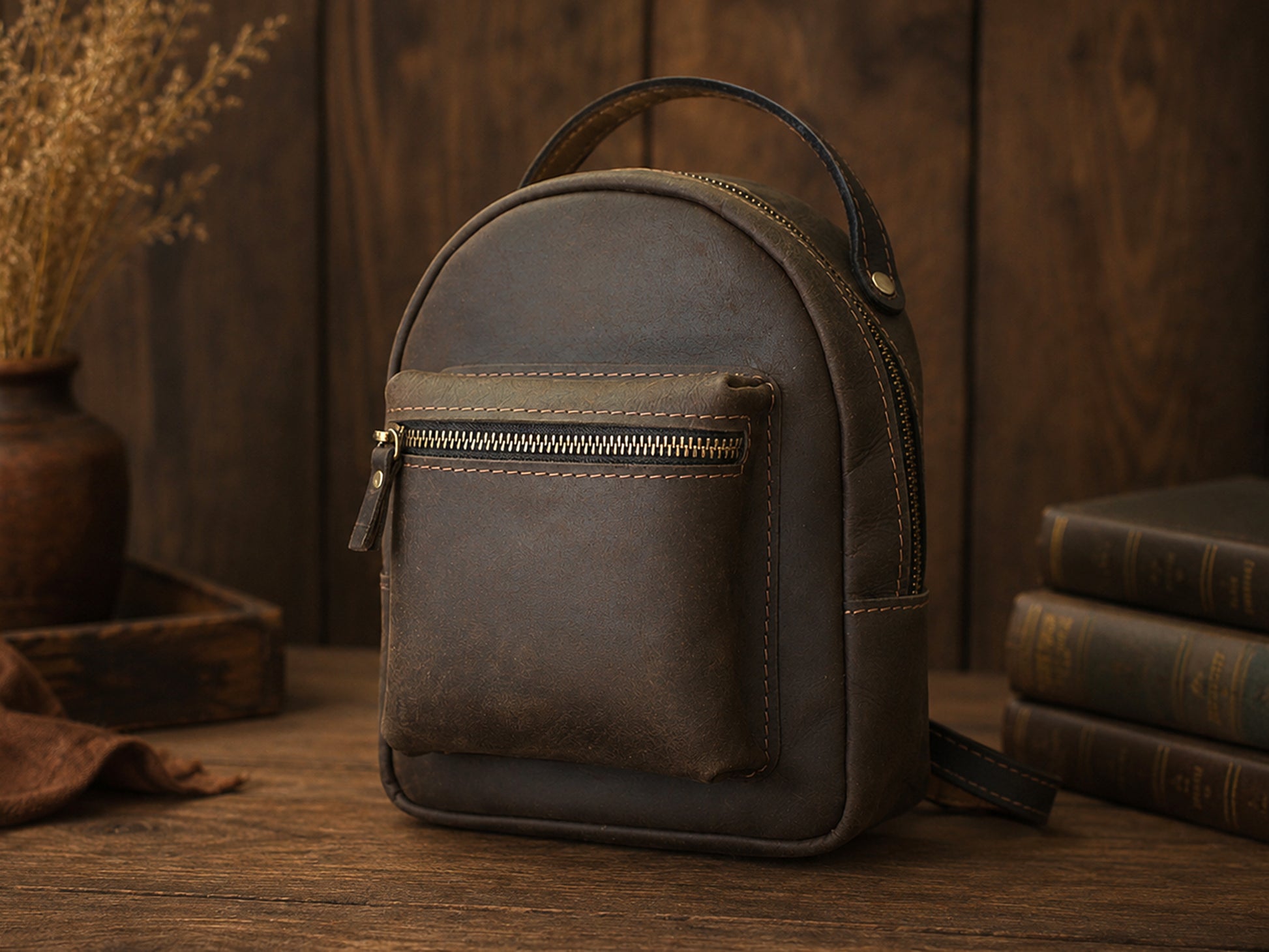 Brown leather backpack on a wooden surface with a warm, rustic background