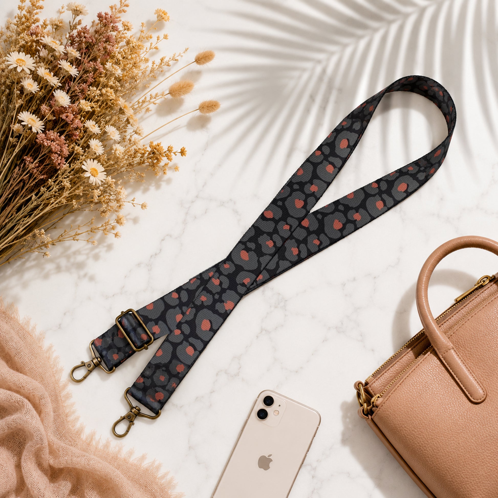 Patterned lanyard with phone and handbag on a light surface