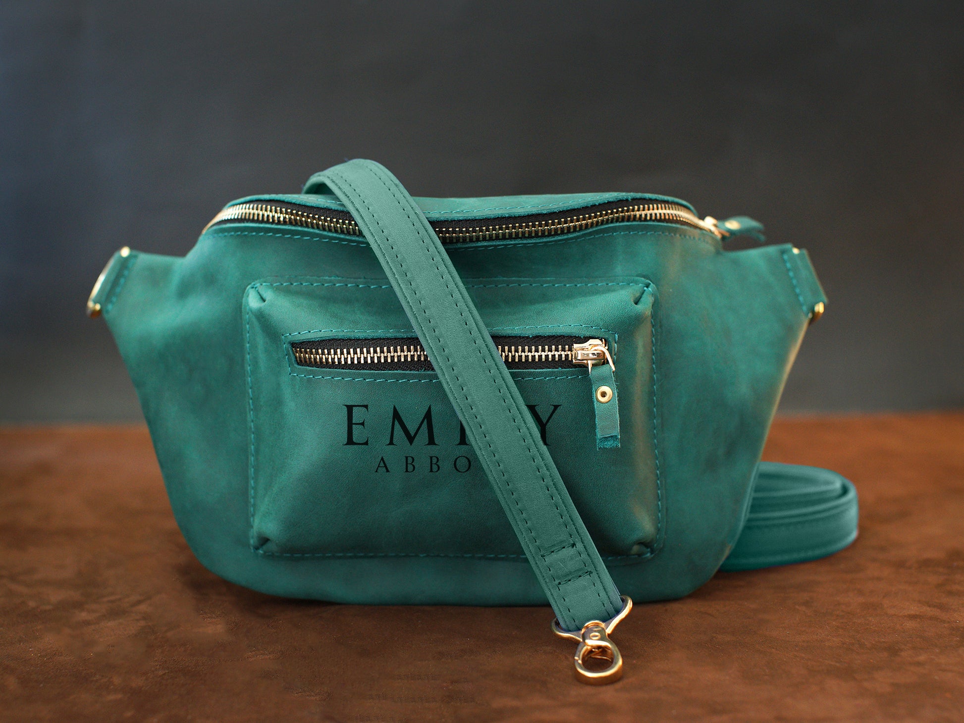 Close-up of leather crossbody sling zipper and hardware detail