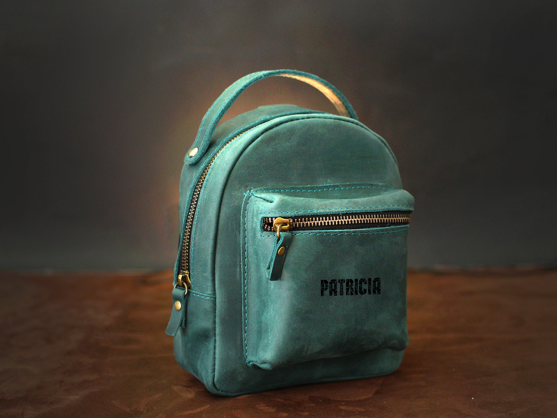 Brown leather mini backpack with custom monogram engraving, front view