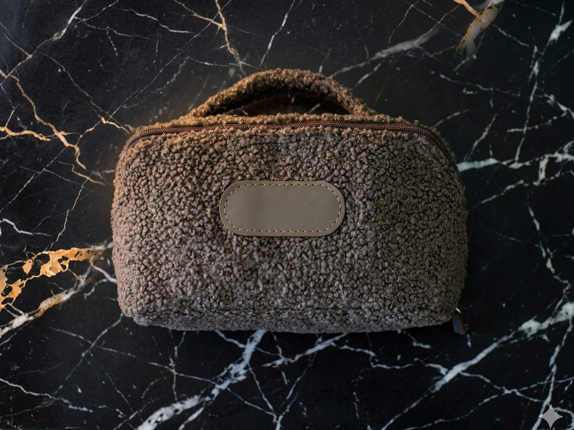 Brown textured pouch with a beige label on a black marble background