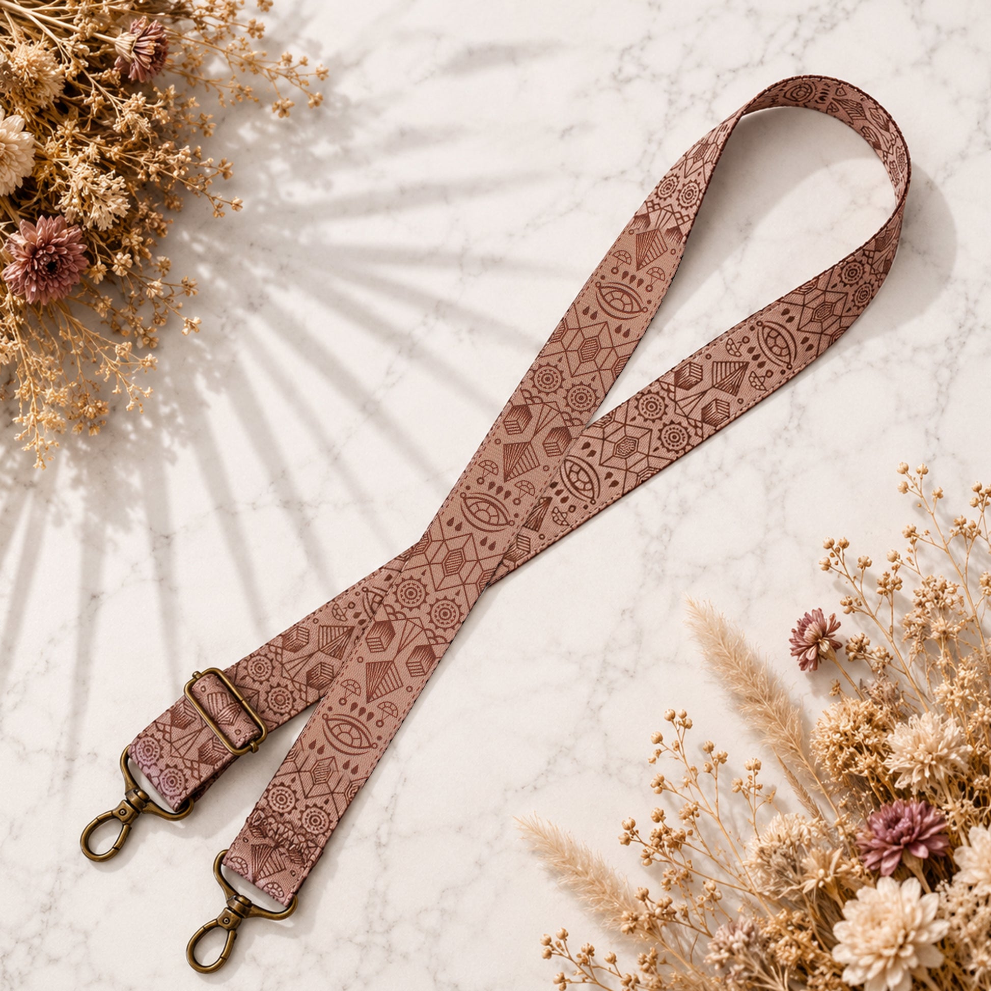 Decorative lanyard with intricate patterns on a light background with dried flowers.
