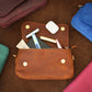 Natural leather crossbody pouch with warm patina, artisan craftsmanship