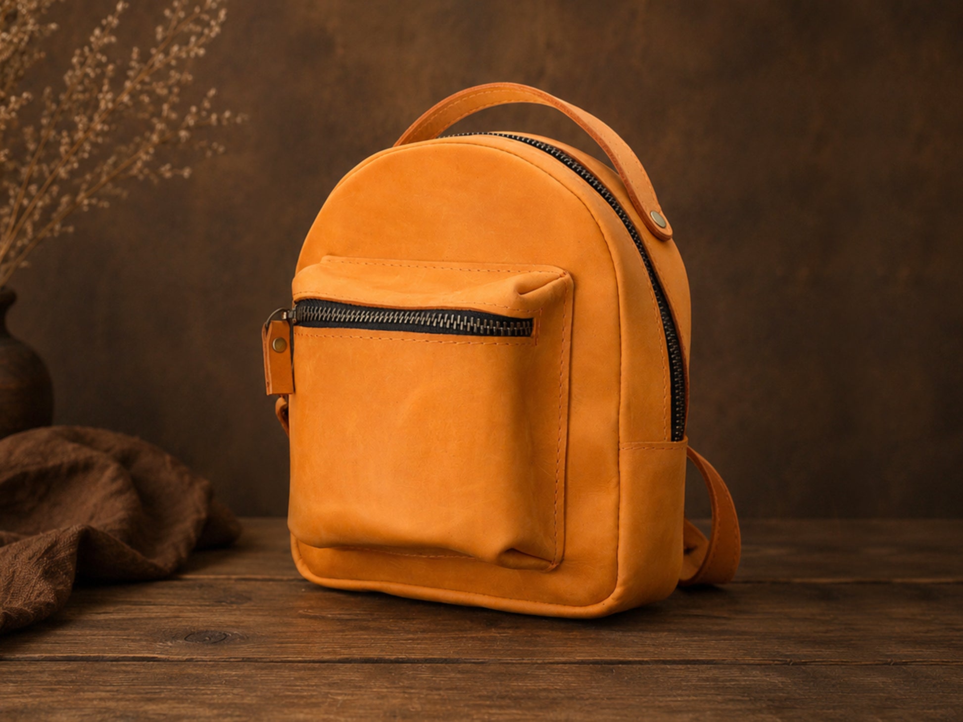 Orange backpack on a wooden surface with a brown background