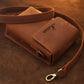 Brown leather bag with strap on a brown background