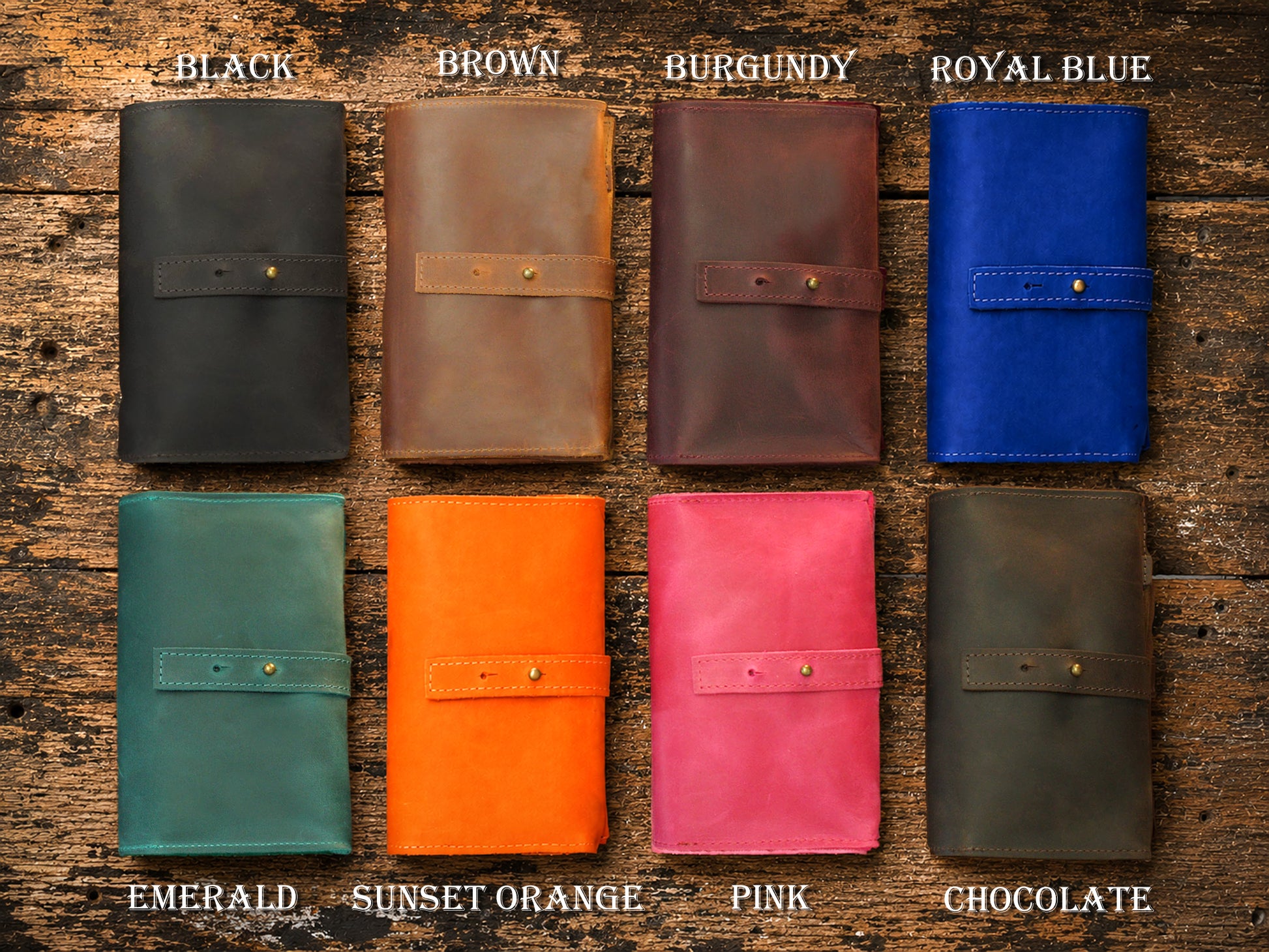 Collection of leather wallets in various colors on a wooden surface