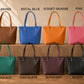 Collection of colorful handbags on a wooden surface with color labels above each.