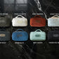 Set of small bags in various colors on a dark marble background