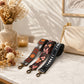 Three floral-patterned strap options on a marble surface with a beige handbag and decorative elements.