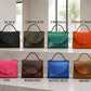 Collection of handbags in various colors on a neutral background