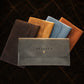Leather clutch collection with personalized engravings, lifestyle flat lay