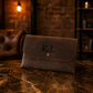 Brown leather clutch with custom monogram engraving, front view