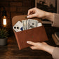 Personalized monogram engraving on handcrafted leather clutch