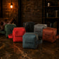Collection of personalized leather bags on a marble surface with a rustic background.
