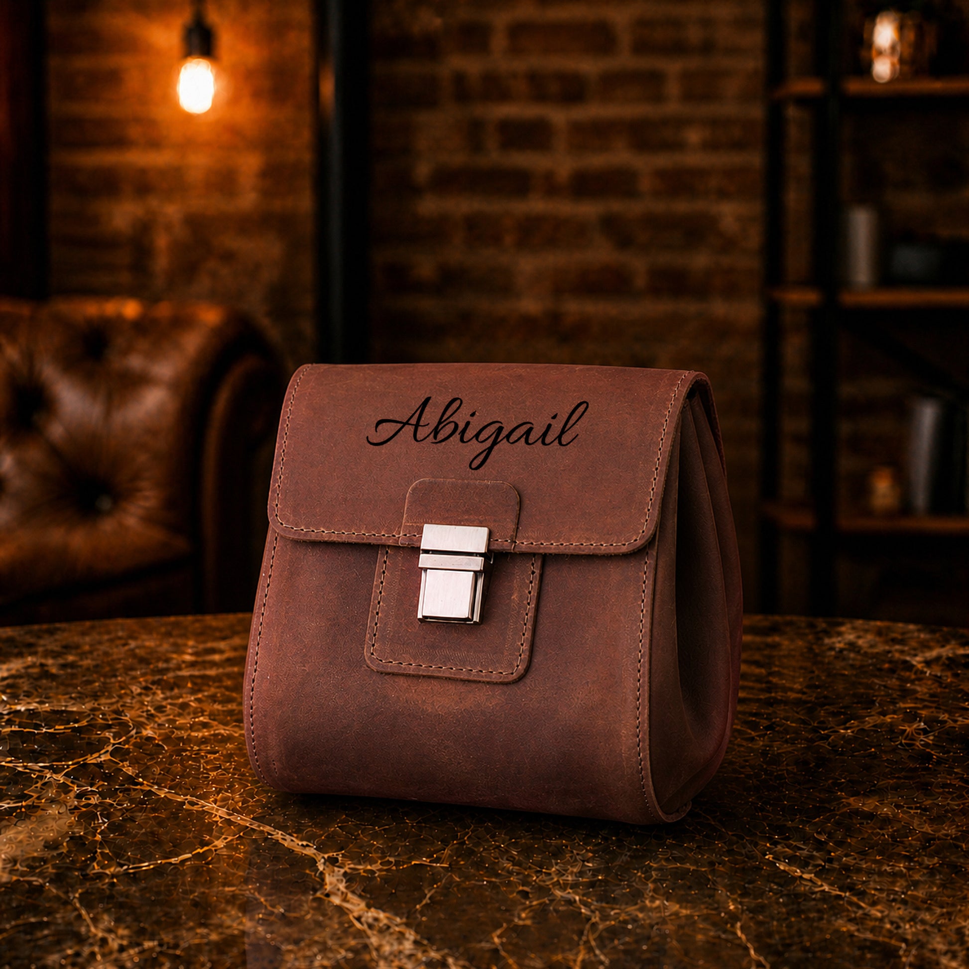 Brown leather dopp kit with custom monogram engraving, front view