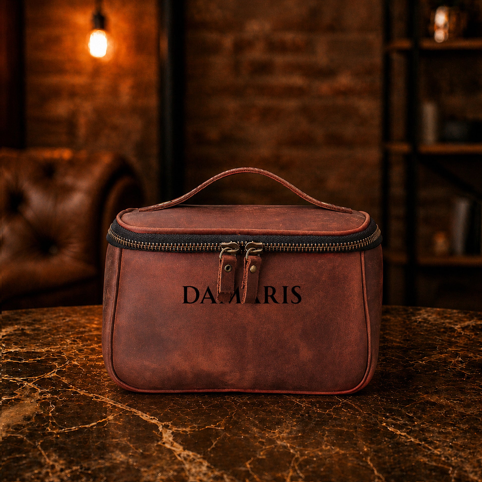 Brown leather toiletry bag with custom monogram engraving, front view