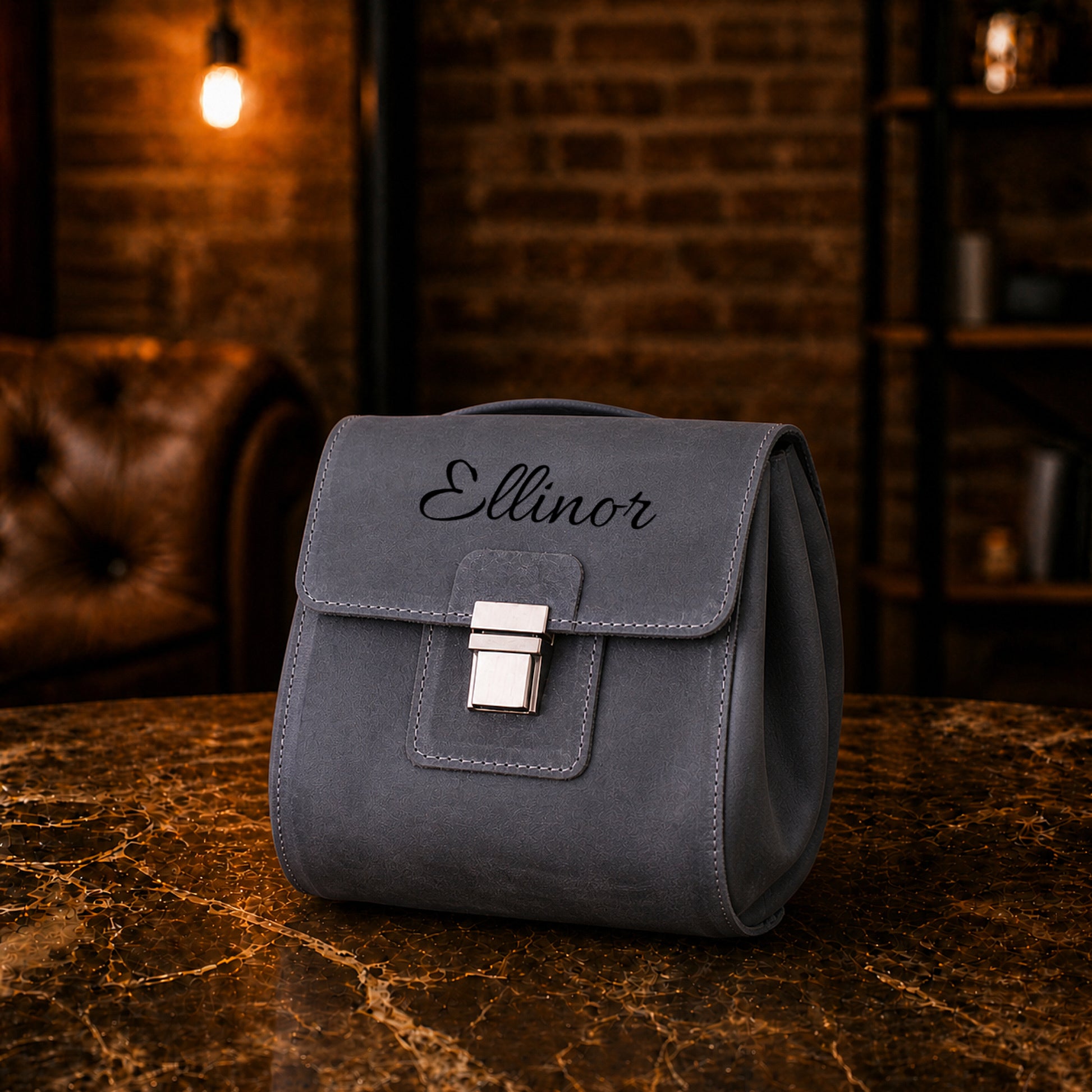 Minimalist leather cosmetic bag with clasp closure, handcrafted design
