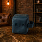 Blue leather pouch with 'R K' logo on a marble surface with a warm-toned background