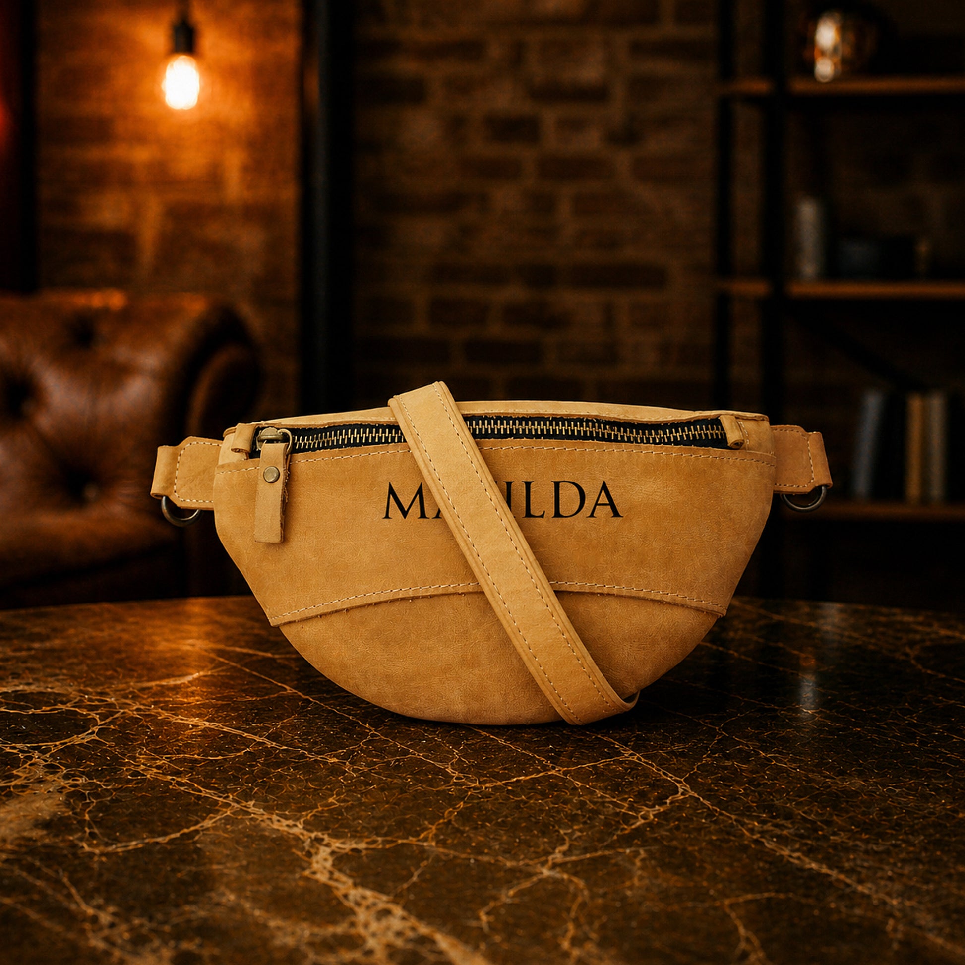 Leather fanny pack zipper and closure detail, durable brass hardware