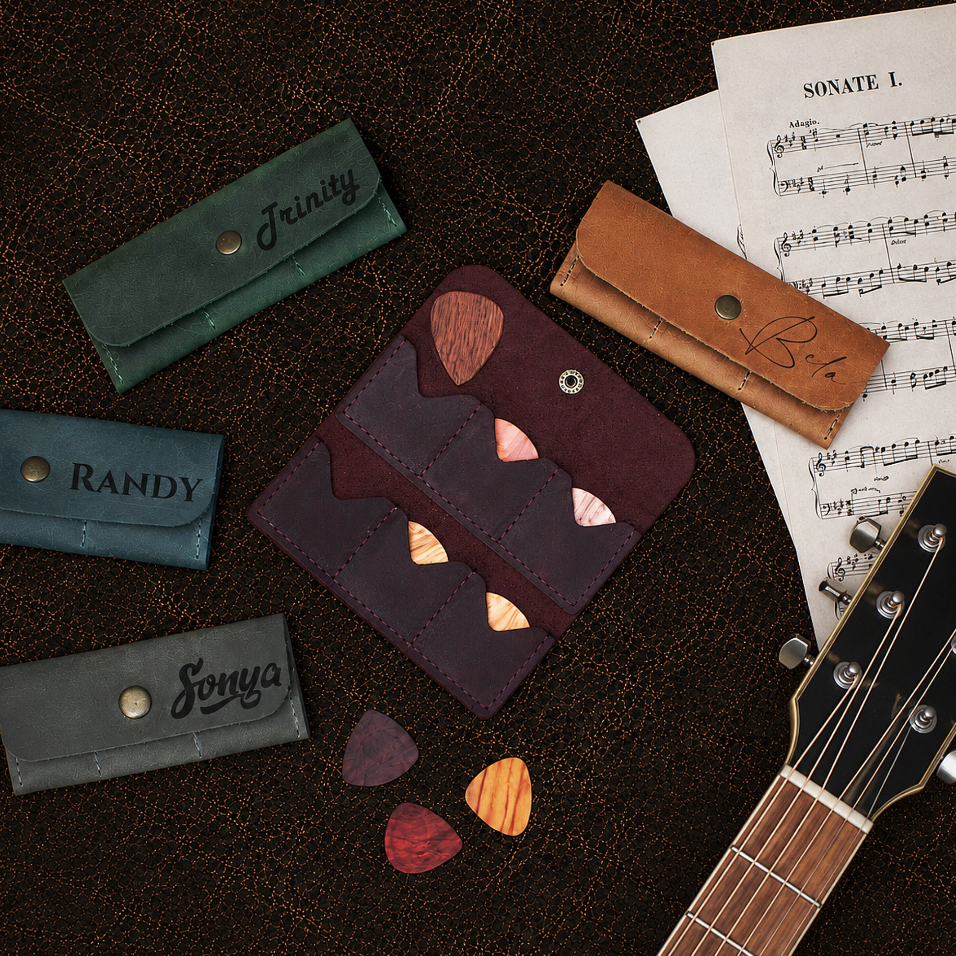 Person holding personalized leather guitar pick holder, lifestyle photo