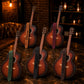 Six acoustic guitars with branded names on a dark surface, possibly in a bar setting.