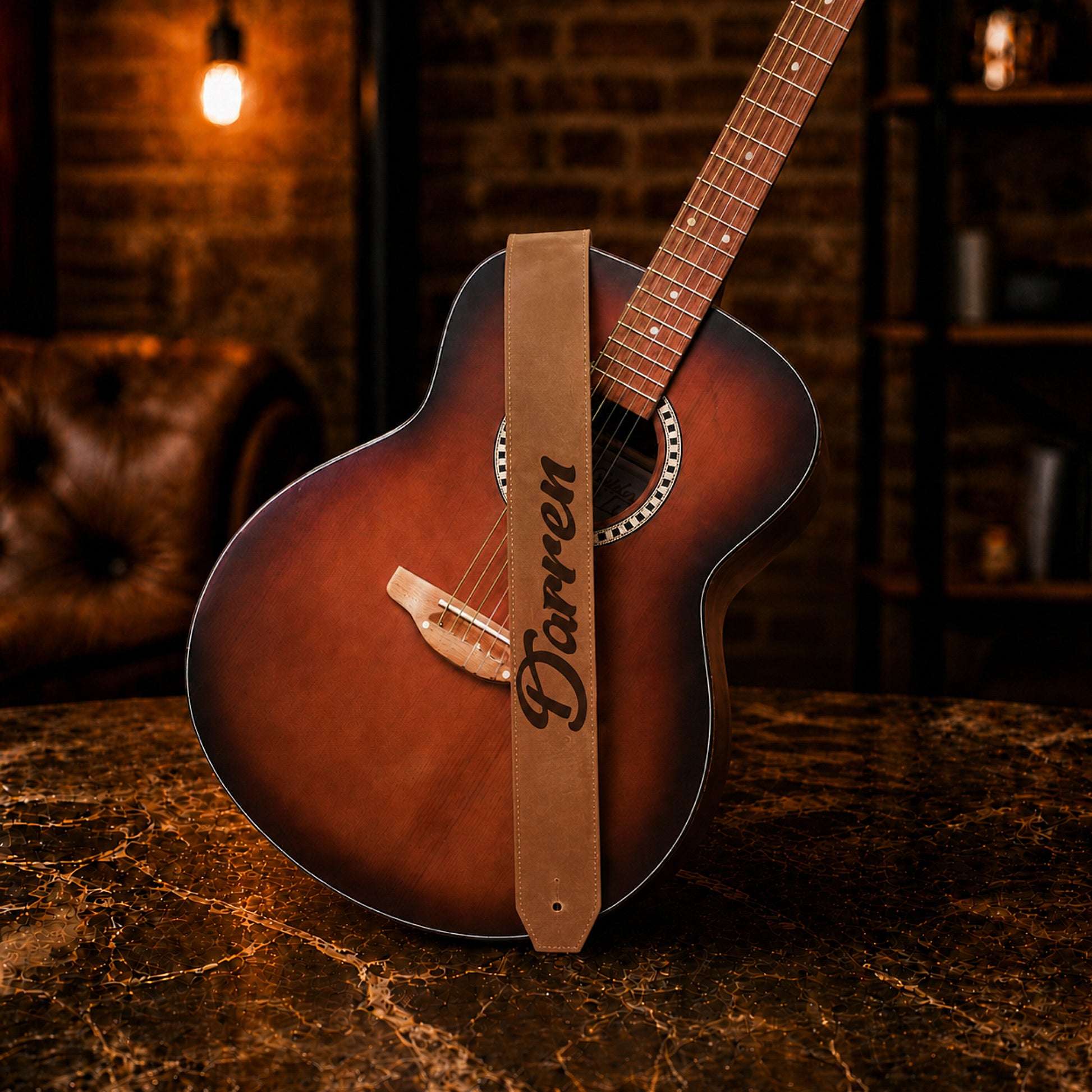 Brown leather guitar strap with custom monogram engraving, front view