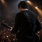 Person playing guitar on stage with lights and audience in the background