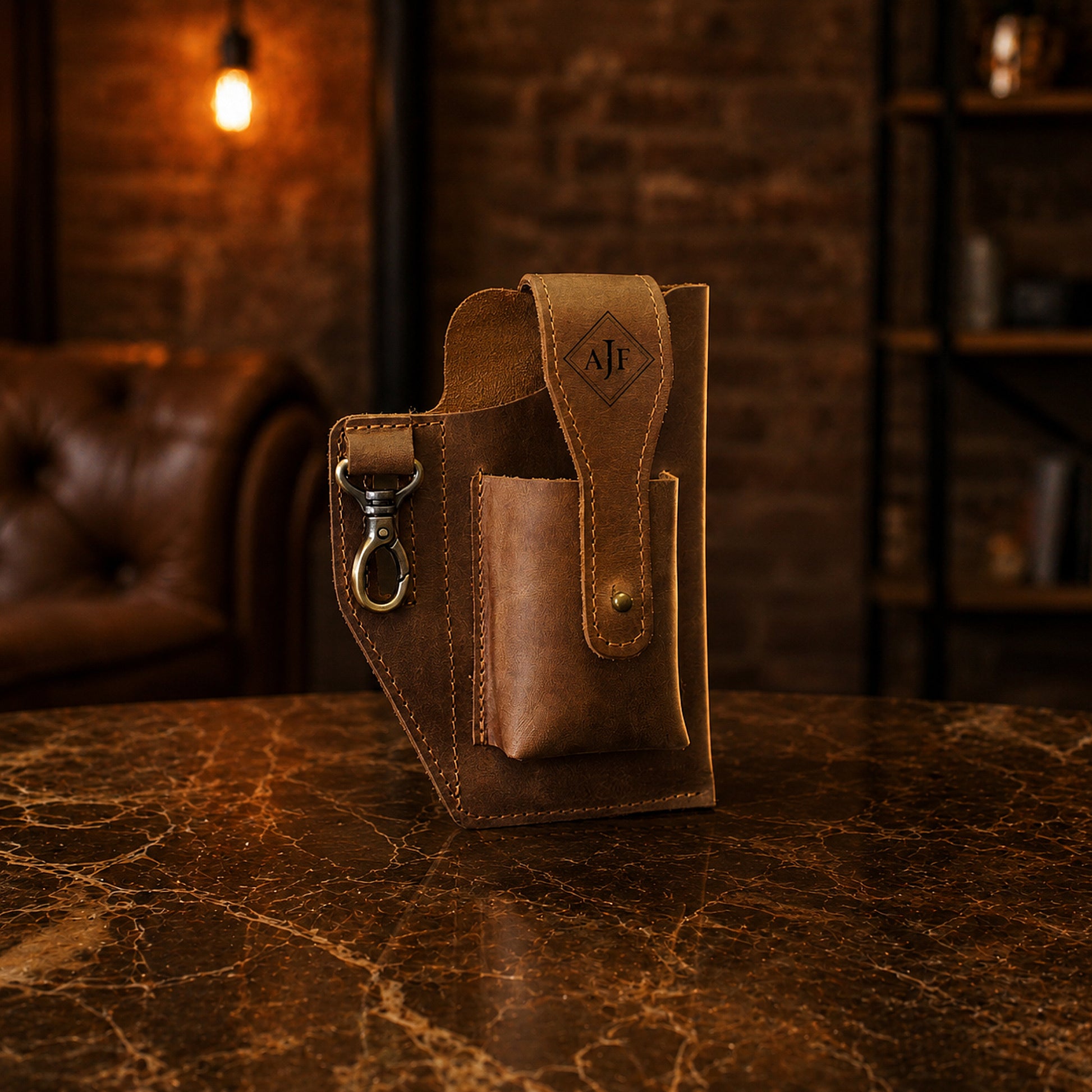 Brown leather utility pouch with custom monogram engraving, front view