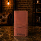 The Tech Wrap leather pouch open, showing cord storage compartments