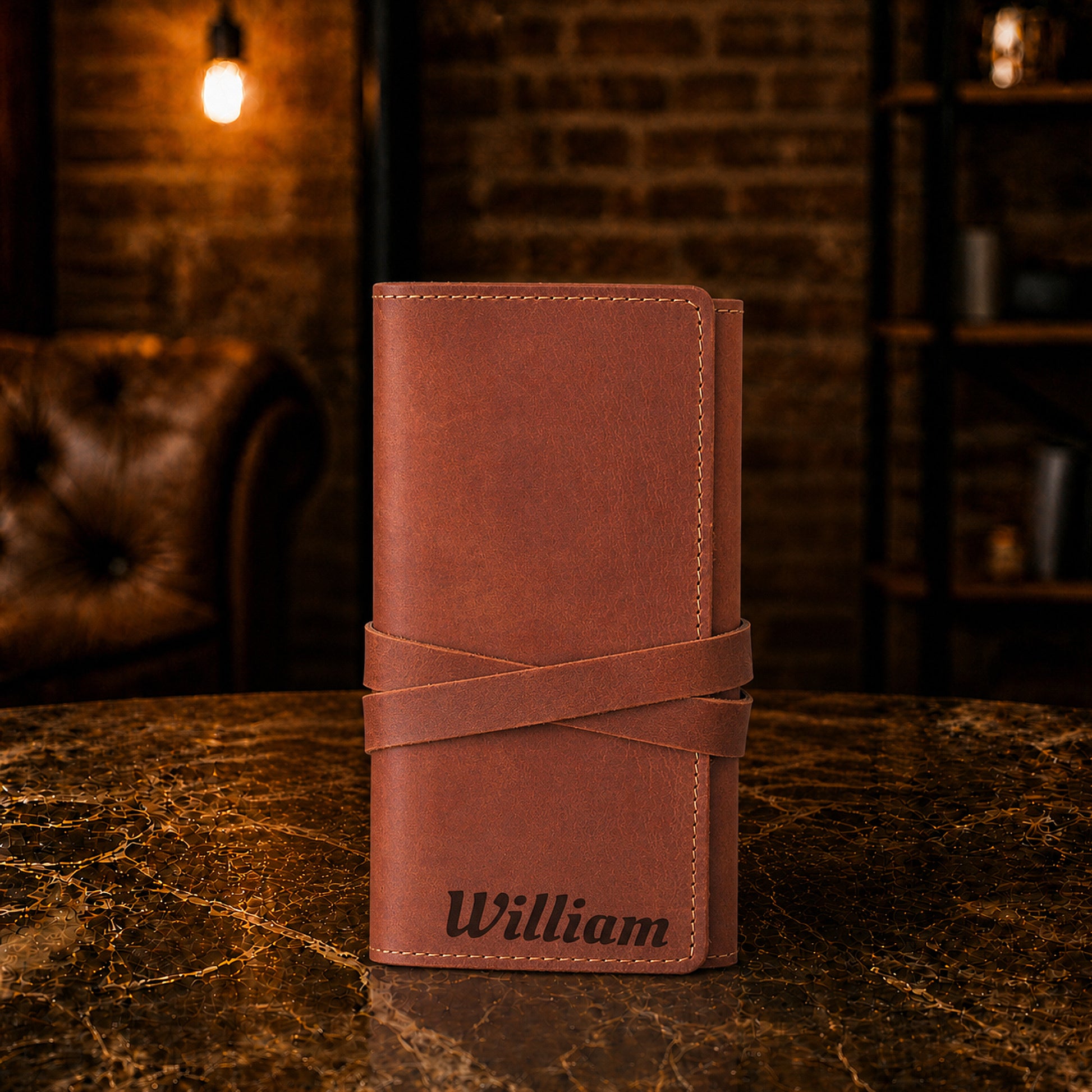 The Tech Wrap leather pouch open, showing cord storage compartments
