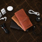 Brown leather cable organizer with custom monogram engraving, front view