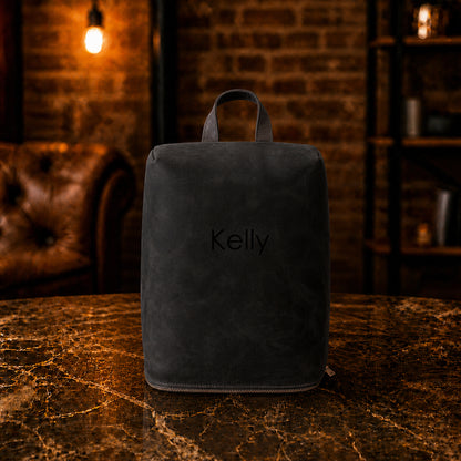 Multiple leather shoe bags with monogram initials on textured surface