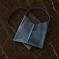 The Artisan Slouch leather bag in use outdoors, warm earthy tones