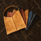 Close-up of leather tote bag strap and hardware detail