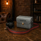Personalized leather bags with names, flat lay on dark background