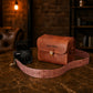 Natural leather camera bag with warm patina, artisan craftsmanship