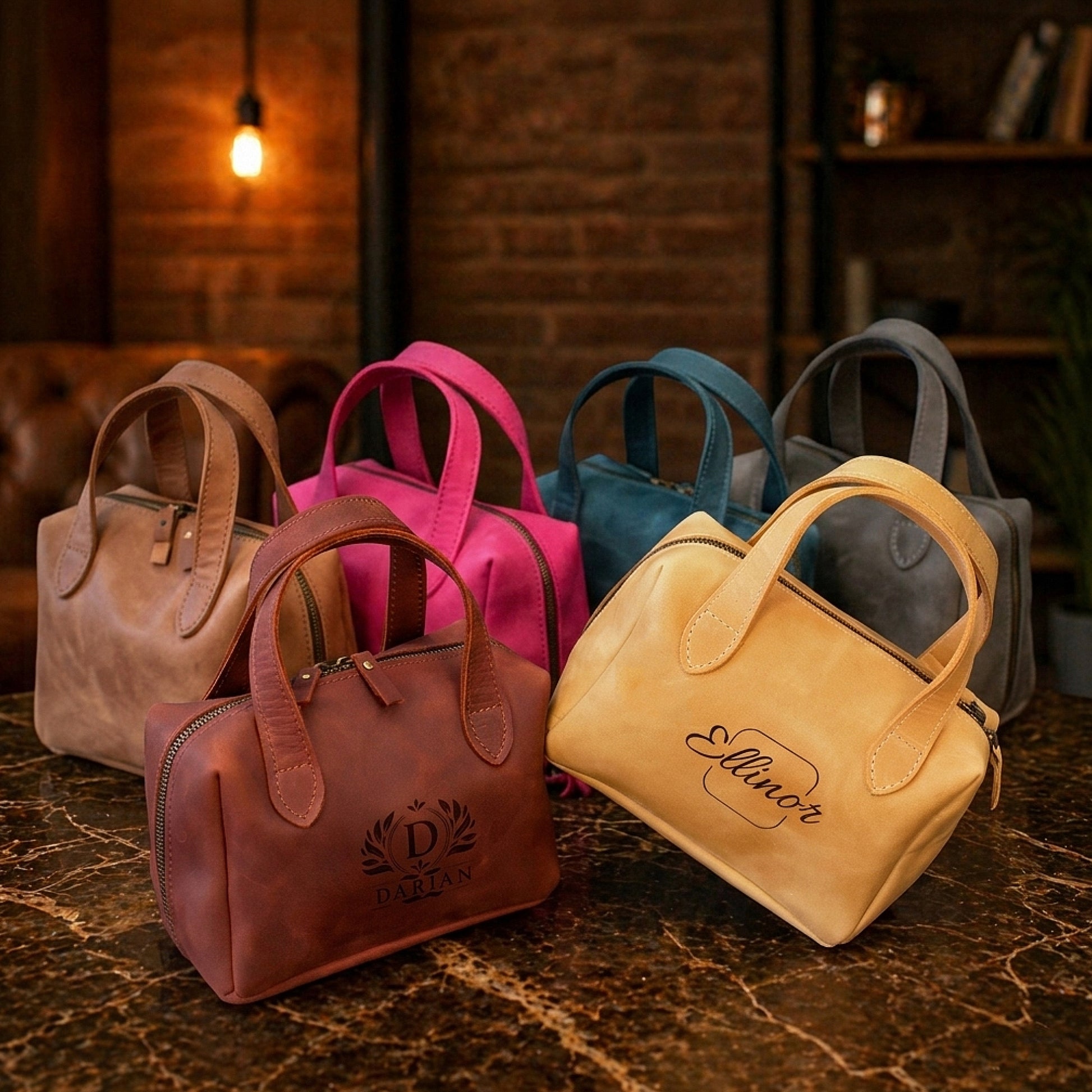 Collection of handbags in various colors on a textured surface with a warm-toned background.