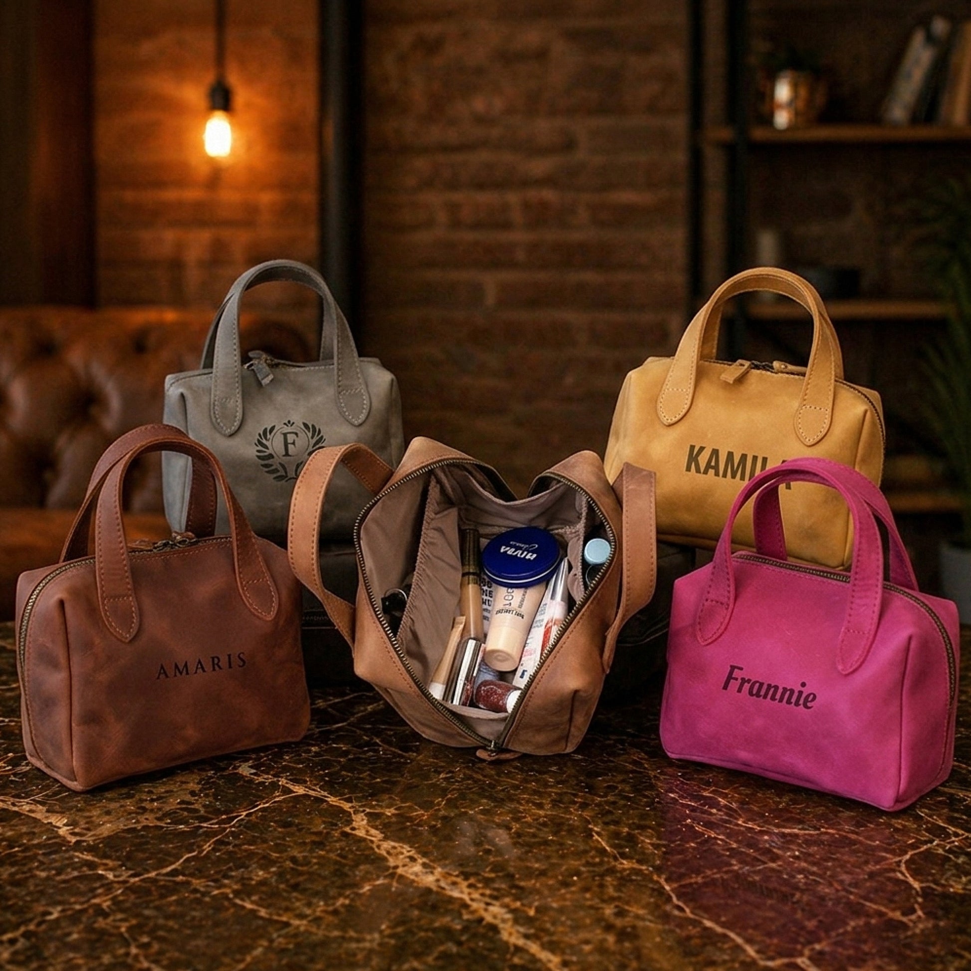 Collection of handbags in various colors with visible branding on a textured surface.