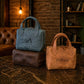 Two leather handbags, one blue and one brown, with visible branding, on a textured surface.