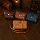 Collection of handcrafted leather mini bags with custom monograms on textured surface