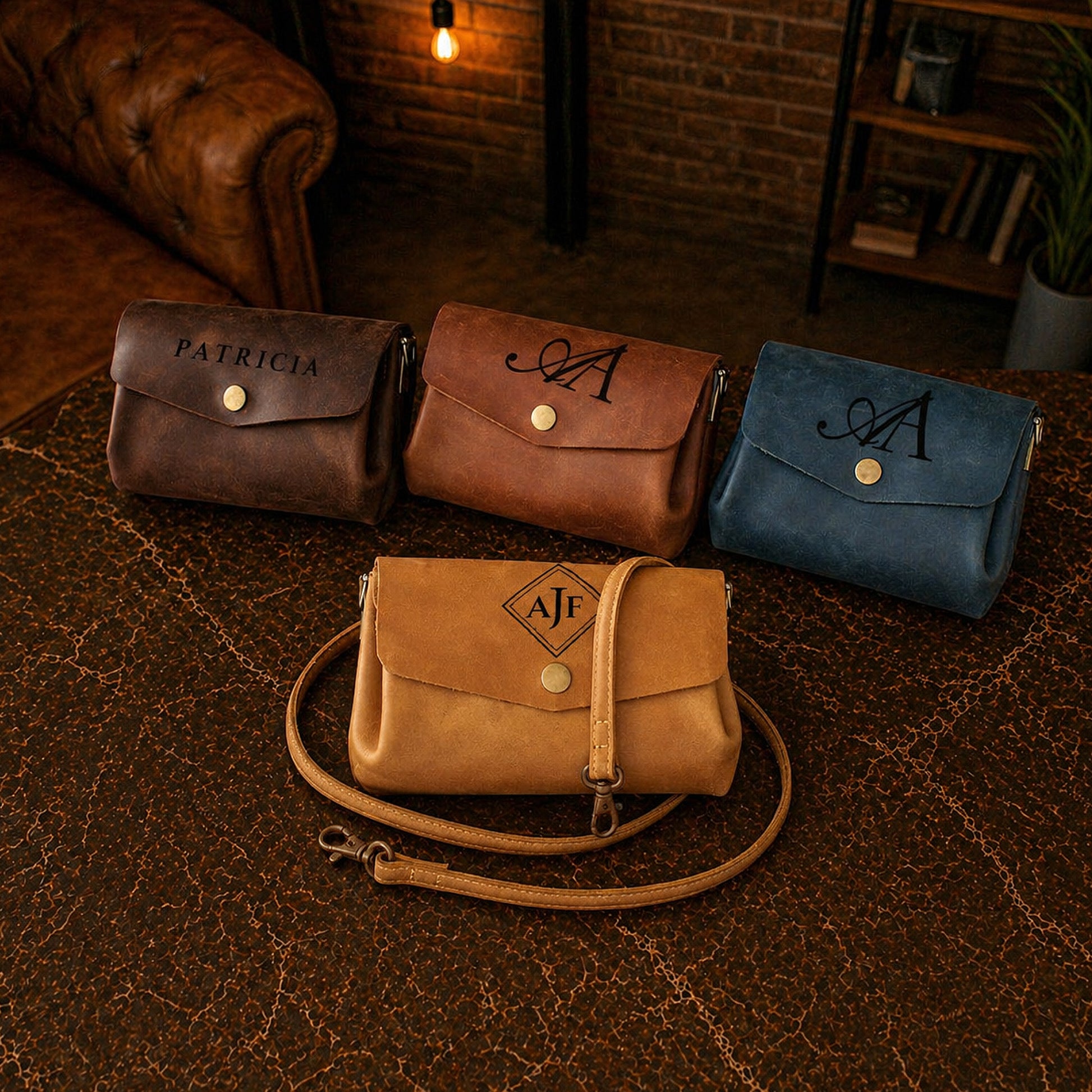 Collection of handcrafted leather mini bags with custom monograms on textured surface